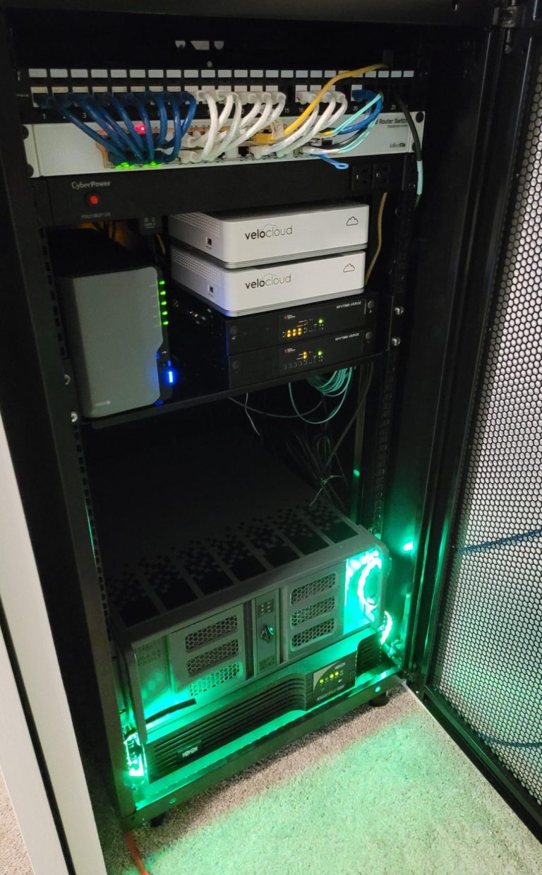 Server rack with network cables, switches, and illuminated components.